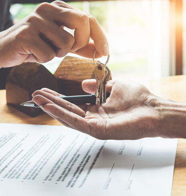 A person handing over the keys to a house